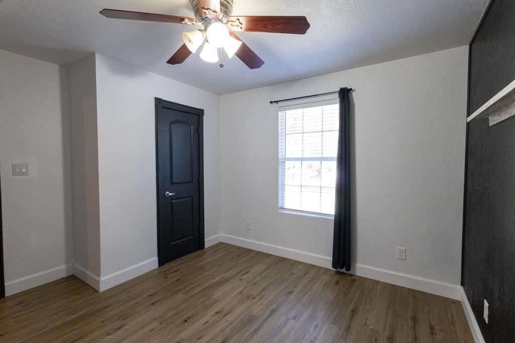 536 Cavin Lane Axtell, TX 76624 - Photo 29 of 40 an empty room with wooden floor chandelier fan and windows