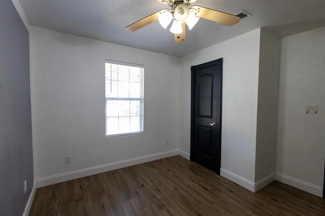 a view of a hallway with wooden floor and a hallway