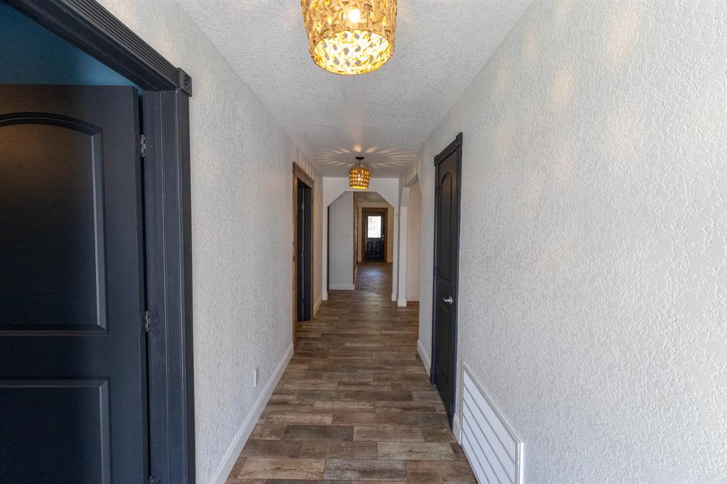 536 Cavin Lane Axtell, TX 76624 - Photo 33 of 40 a view of a hallway with wooden floor and a hallway