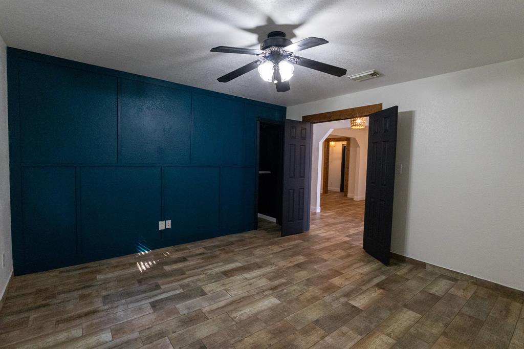 536 Cavin Lane Axtell, TX 76624 - Photo 37 of 40 wooden floor in an empty room with a chandelier fan
