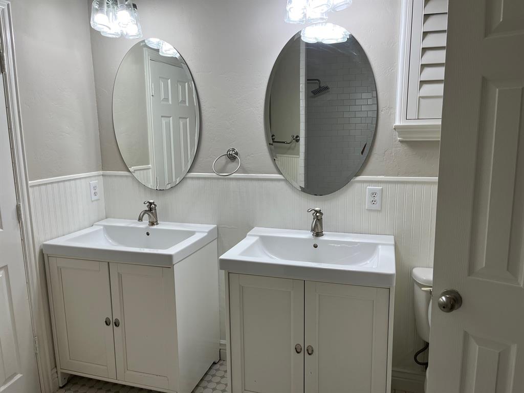 a bathroom with 2 sink and a mirror