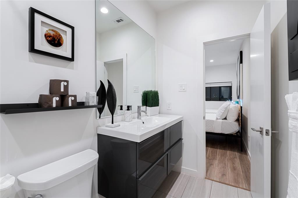 1002 Mobile Street, Unit 1 Dallas, TX 75208 - Photo 25 of 34 a en suite bathroom with a toilet sink and mirror
