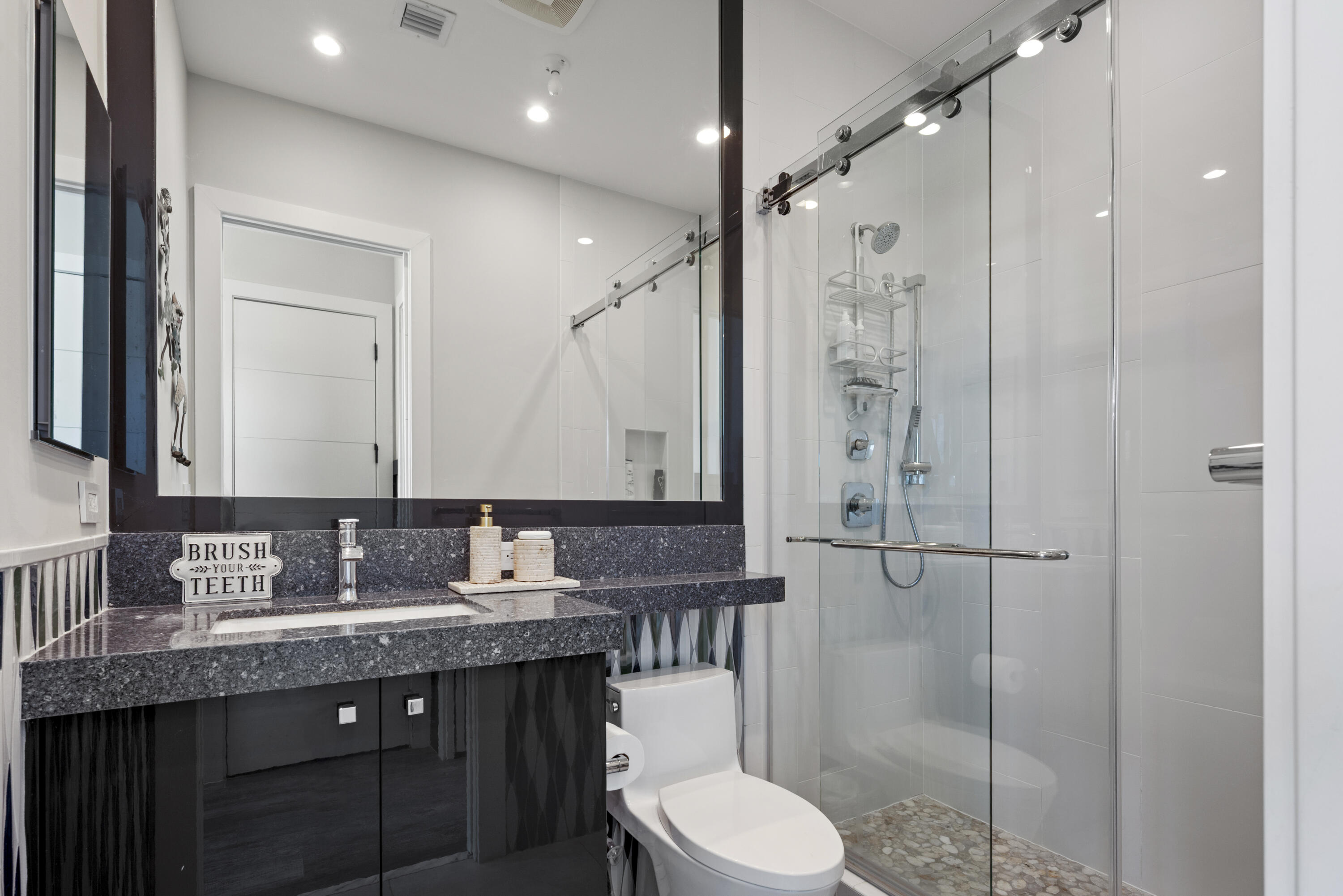 9771 Chianti Classico Terrace Boca Raton, FL 33496 - Photo 78 of 114 a bathroom with a granite countertop sink toilet a mirror and shower