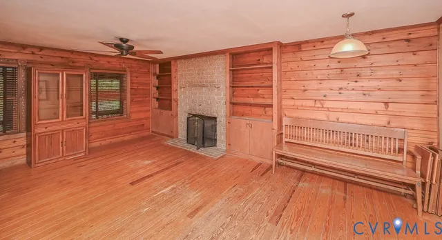 wooden floor in an empty room with a fireplace