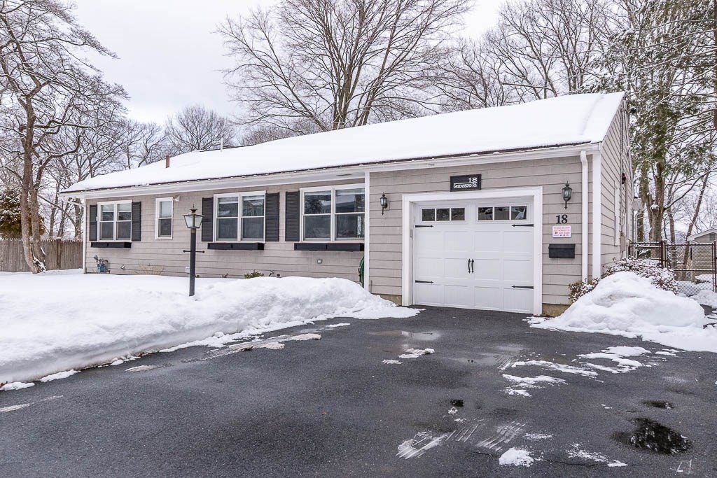18 Greensboro Road Dedham, MA 02026 - Photo 1 of 39 a view of a house with a yard and garage
