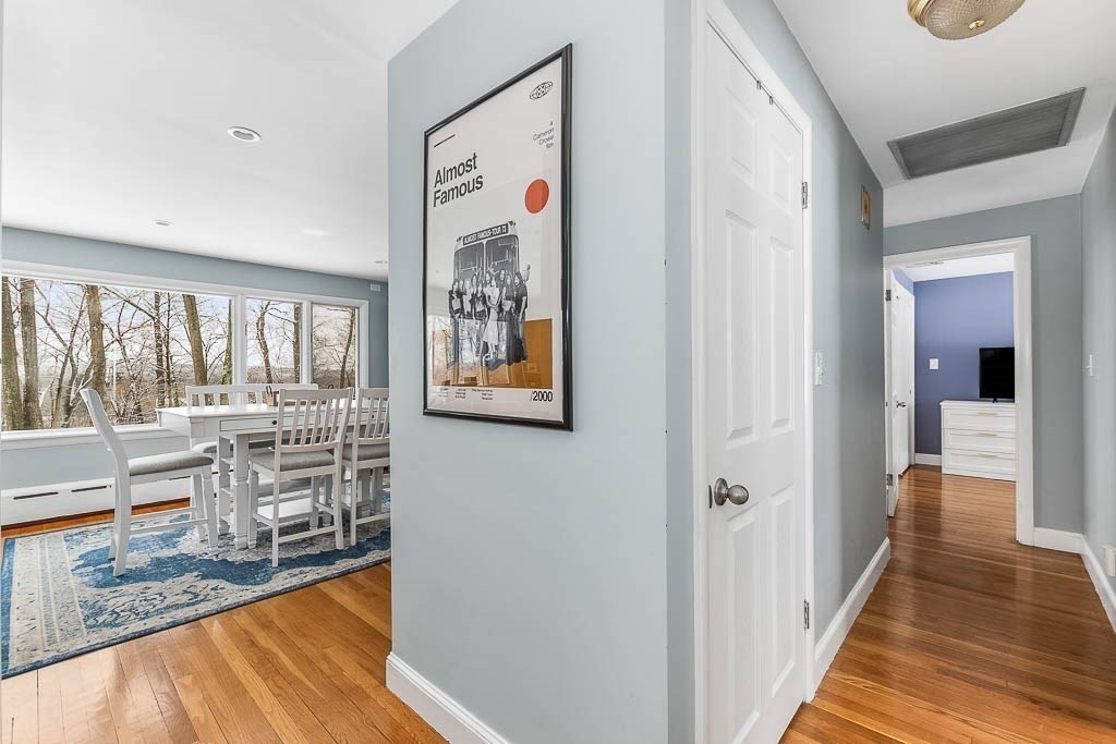 18 Greensboro Road Dedham, MA 02026 - Photo 11 of 39 a view of a hallway with wooden floor and dining room