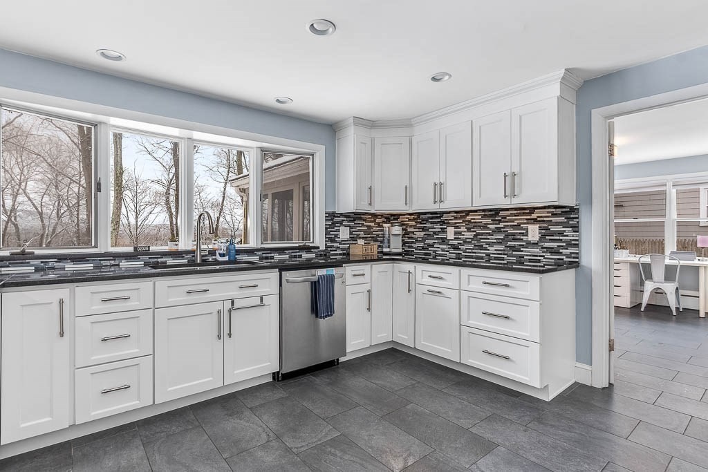 18 Greensboro Road Dedham, MA 02026 - Photo 15 of 39 a kitchen with granite countertop white cabinets white appliances with a sink and dishwasher
