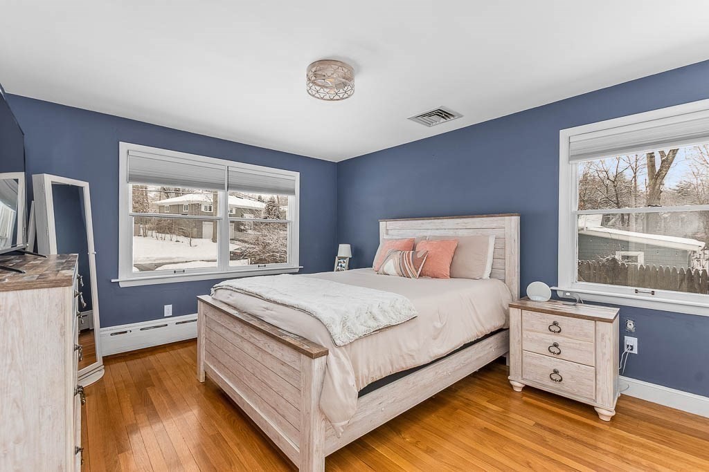 18 Greensboro Road Dedham, MA 02026 - Photo 18 of 39 a bed room with a bed and a large window