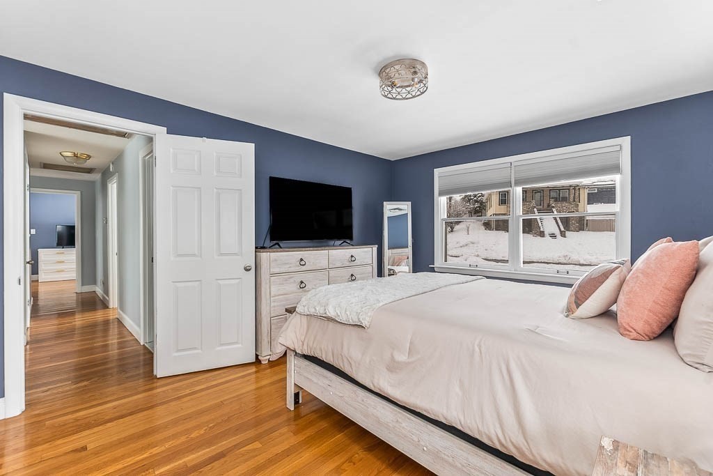 18 Greensboro Road Dedham, MA 02026 - Photo 19 of 39 a bedroom with a bed and a flat screen tv