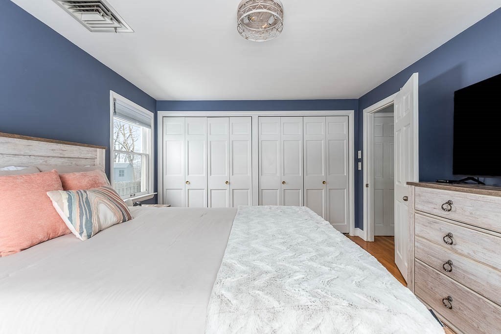 18 Greensboro Road Dedham, MA 02026 - Photo 20 of 39 a bedroom with a bed and a flat screen tv