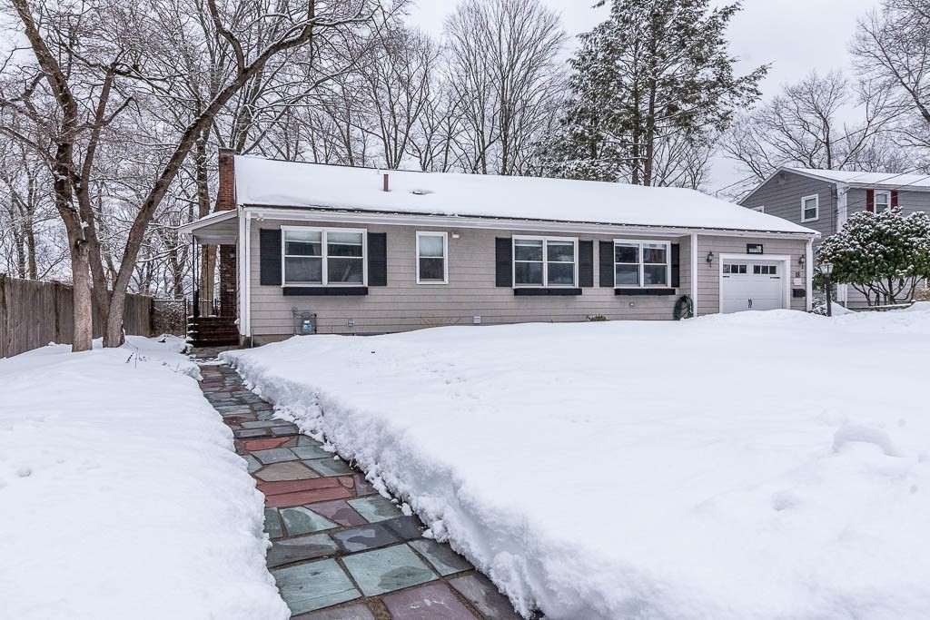 18 Greensboro Road Dedham, MA 02026 - Photo 2 of 39 a view of a house with a yard covered in snow