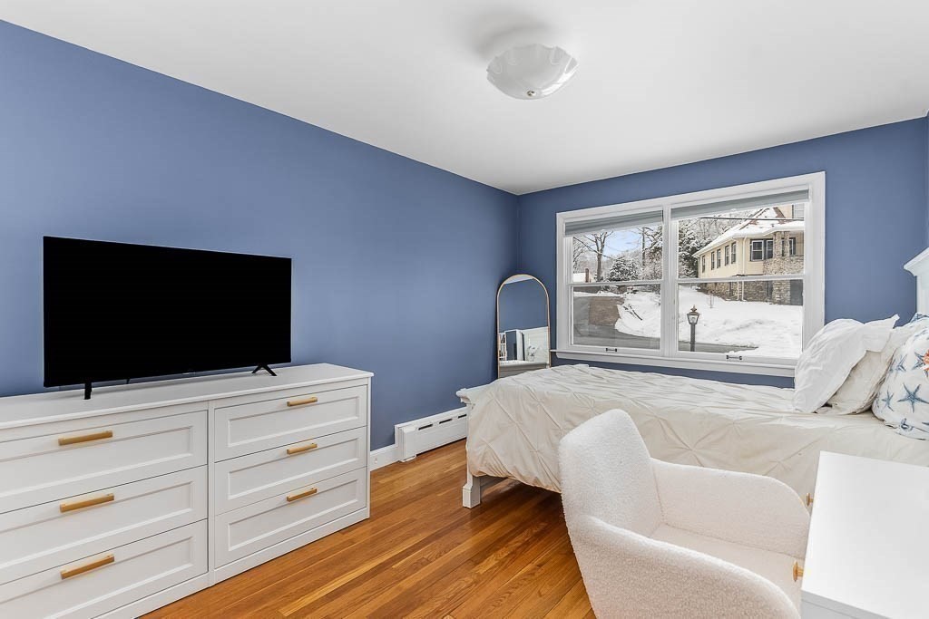 18 Greensboro Road Dedham, MA 02026 - Photo 22 of 39 a bedroom with a bed and a flat screen tv