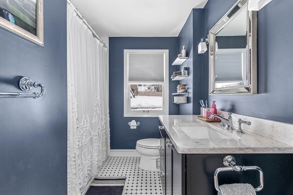 18 Greensboro Road Dedham, MA 02026 - Photo 24 of 39 a bathroom with a granite countertop sink a toilet a mirror and shower