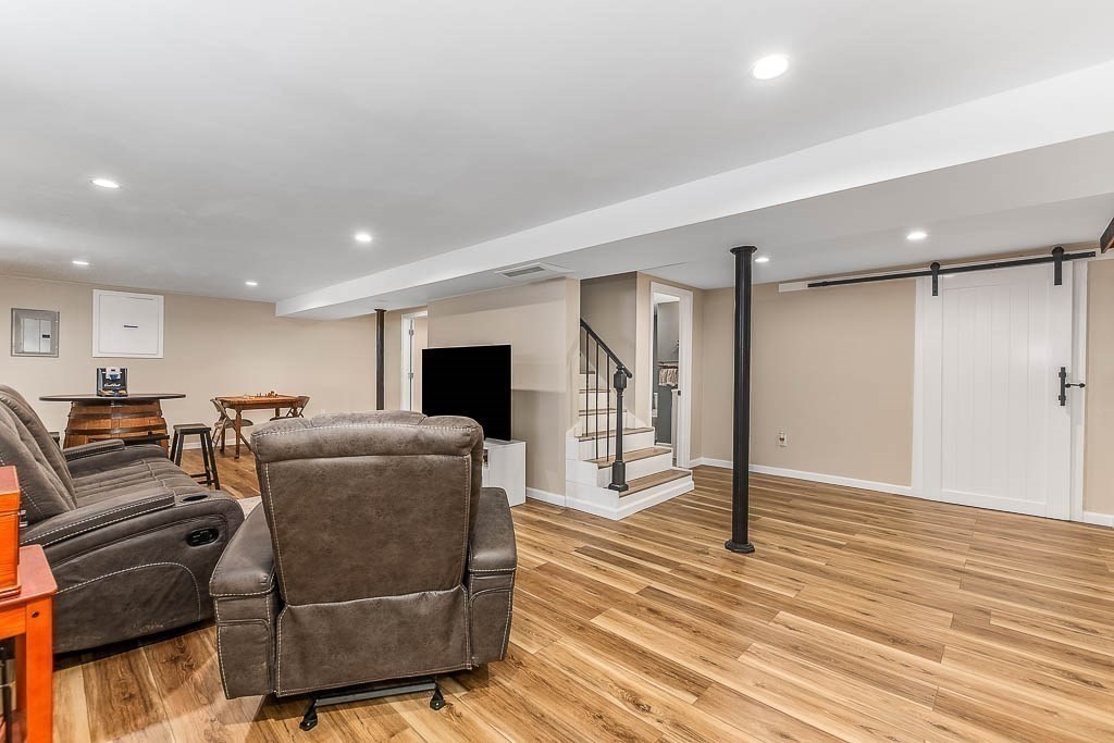18 Greensboro Road Dedham, MA 02026 - Photo 25 of 39 a living room with furniture and a wooden floor