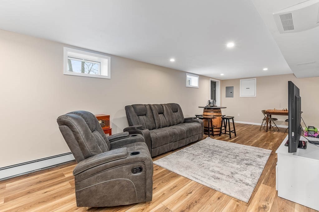 18 Greensboro Road Dedham, MA 02026 - Photo 26 of 39 a living room with furniture and a wooden floor