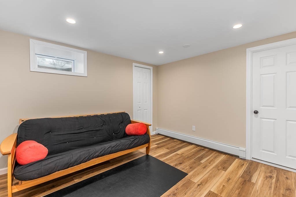 18 Greensboro Road Dedham, MA 02026 - Photo 30 of 39 a room with wooden floor and chandelier