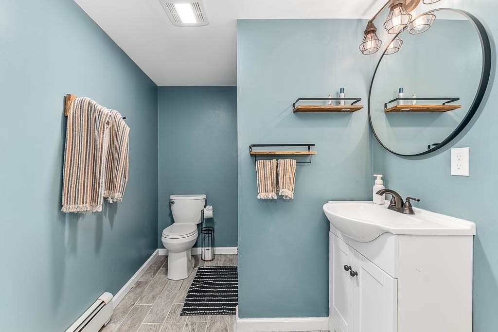 18 Greensboro Road Dedham, MA 02026 - Photo 31 of 39 a bathroom with a sink mirror and toilet