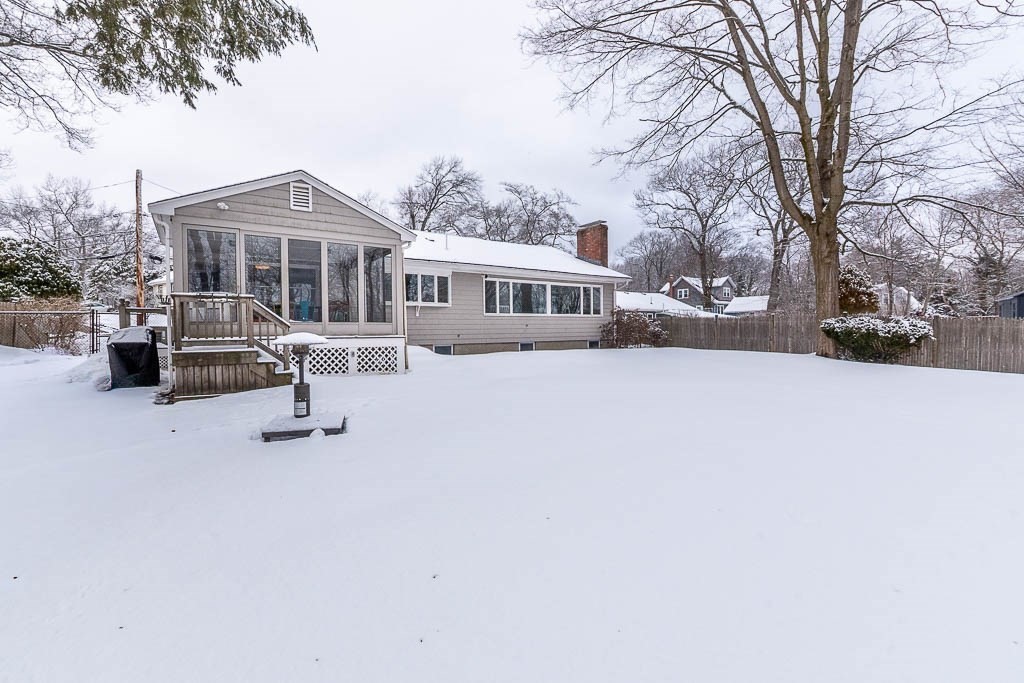 18 Greensboro Road Dedham, MA 02026 - Photo 35 of 39 a front view of house with yard covered in snow