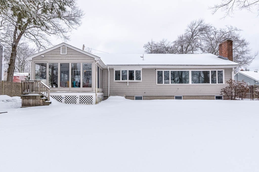 18 Greensboro Road Dedham, MA 02026 - Photo 37 of 39 a front view of a house with a yard and trees