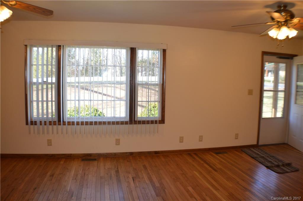 116 Cove Road Rutherfordton, NC 28139 - Photo 9 of 16 a view of an empty room with wooden floor and a window