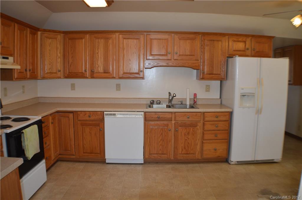 116 Cove Road Rutherfordton, NC 28139 - Photo 10 of 16 a kitchen with stainless steel appliances granite countertop a refrigerator sink and cabinets