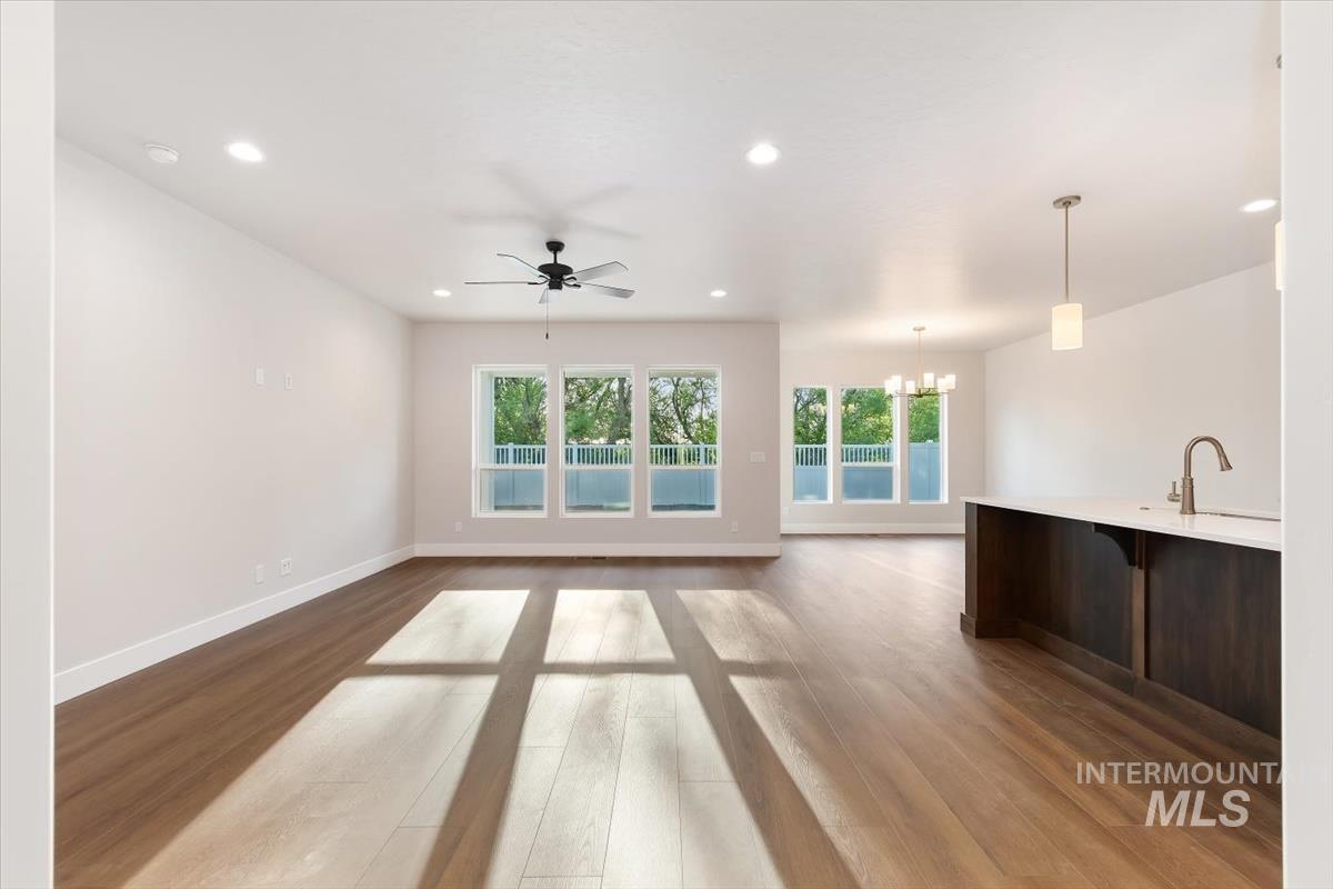 3321 Helios Street Caldwell, ID 83607 - Photo 8 of 35 Open-concept living space featuring wood-finish flooring, a contemporary ceiling fan, and recessed lighting