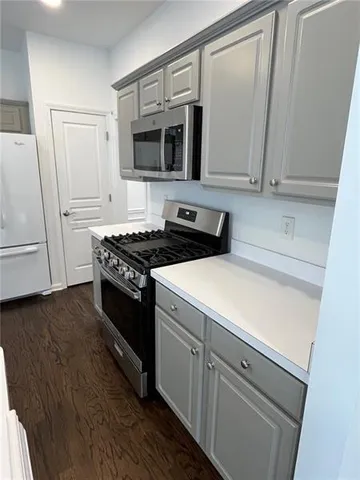 a kitchen with a sink and a microwave