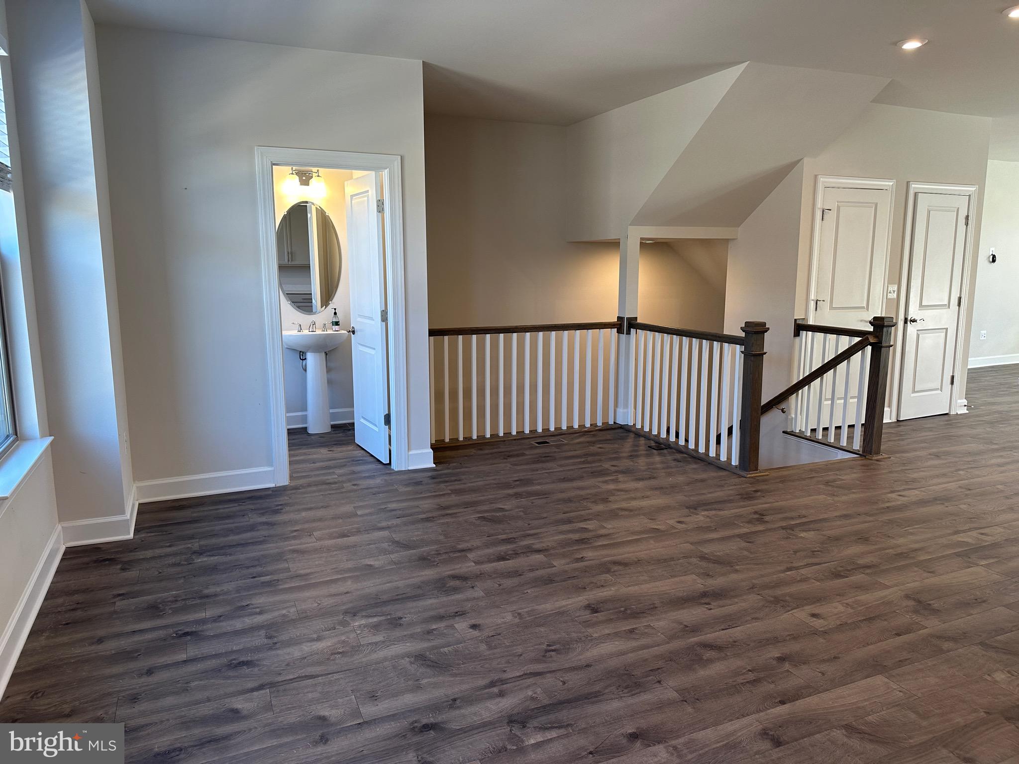 9886 Hopkins Loop Manassas, VA 20110 - Photo 11 of 50 a view of a hallway with wooden floor and stairs