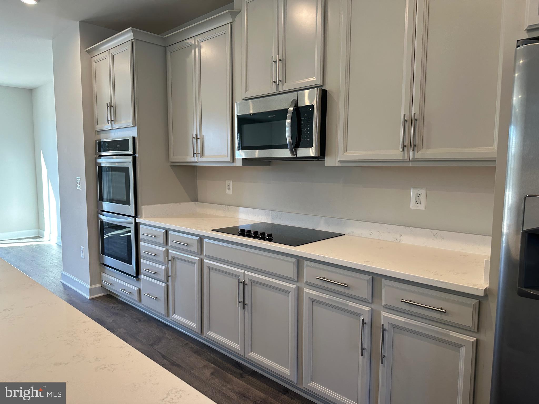 9886 Hopkins Loop Manassas, VA 20110 - Photo 14 of 50 a kitchen with stainless steel appliances white cabinets and a sink