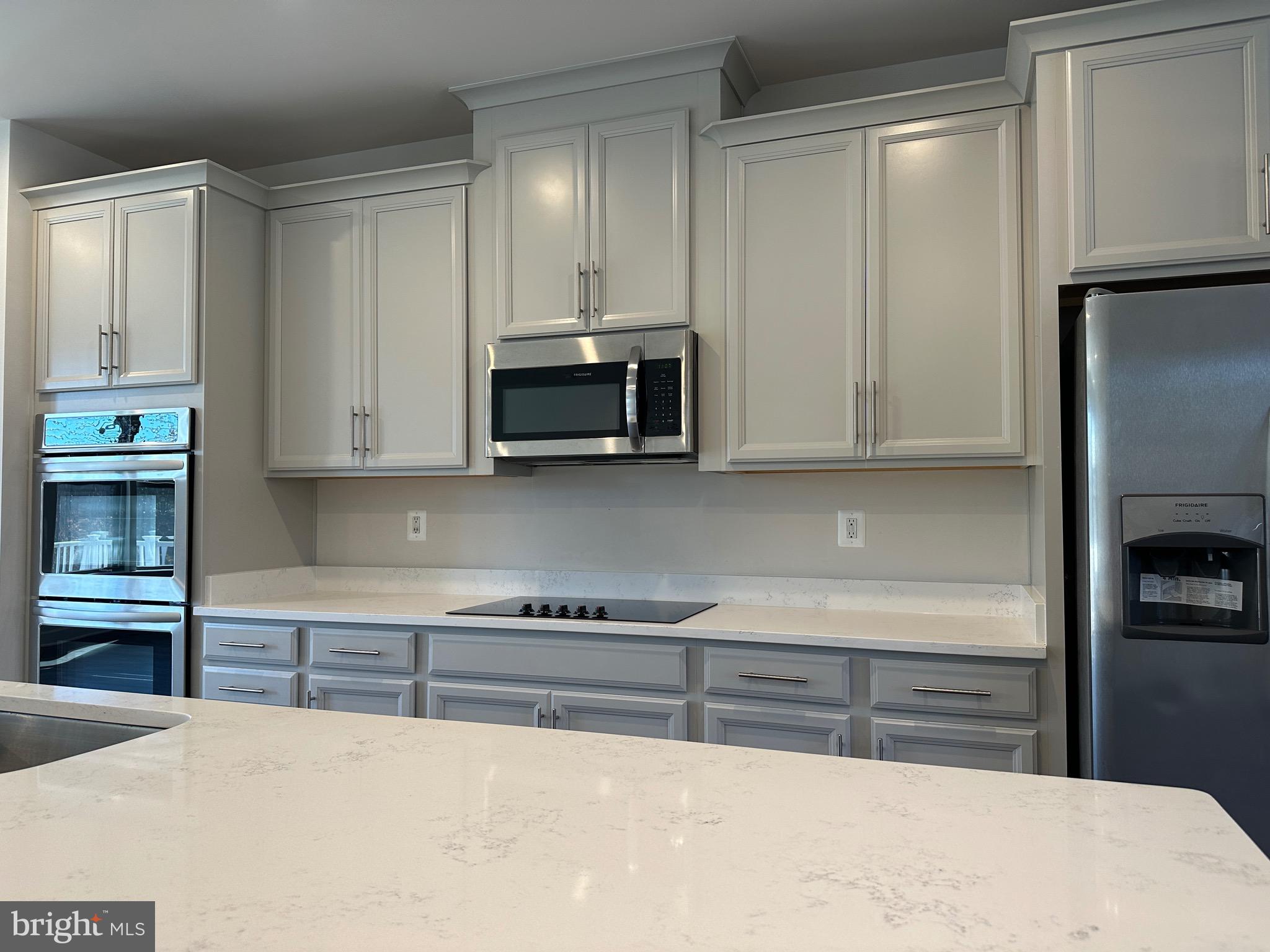 9886 Hopkins Loop Manassas, VA 20110 - Photo 15 of 50 a kitchen with stainless steel appliances a refrigerator and a stove top oven