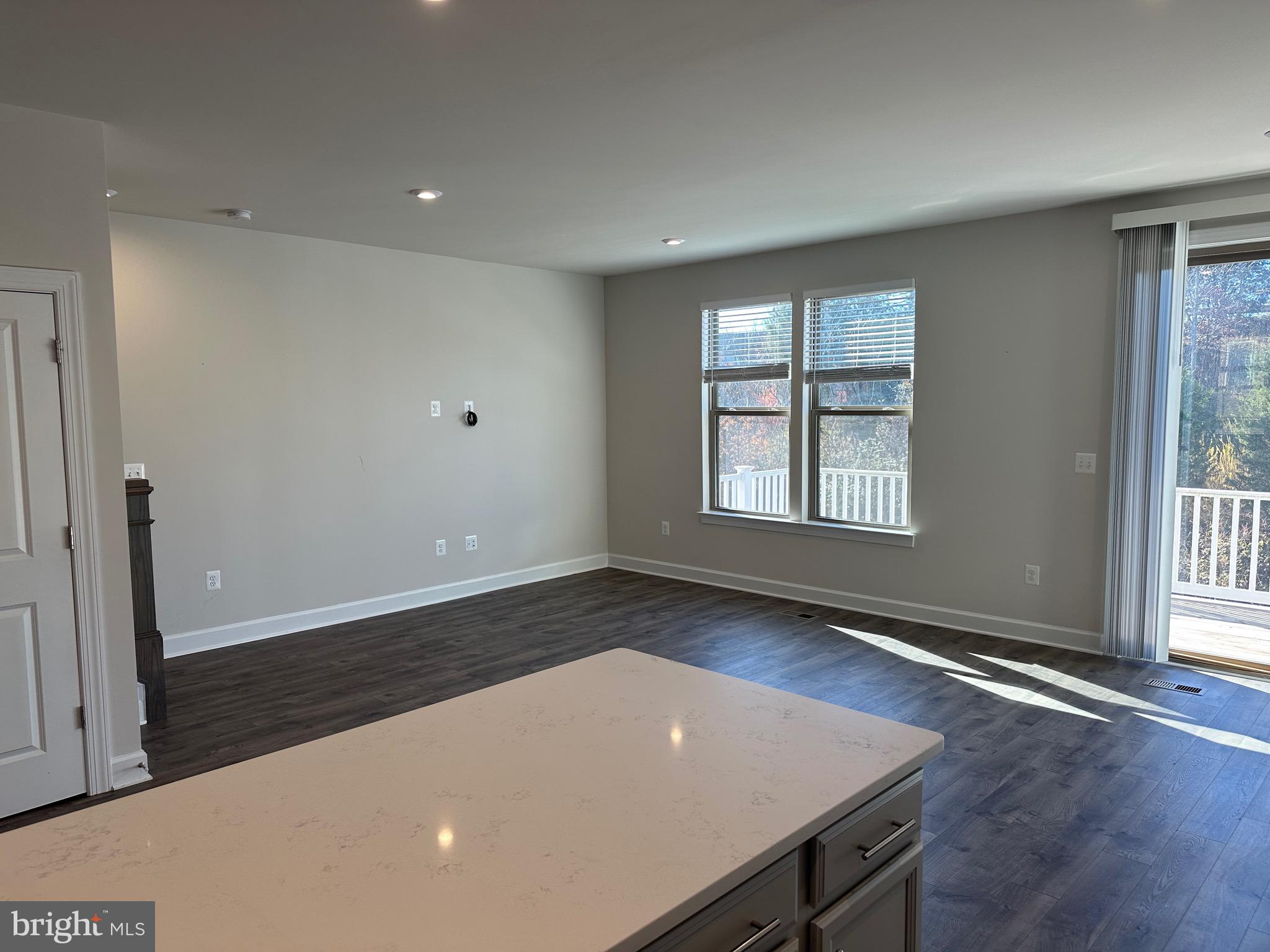 9886 Hopkins Loop Manassas, VA 20110 - Photo 17 of 50 an empty room with wooden floor and windows