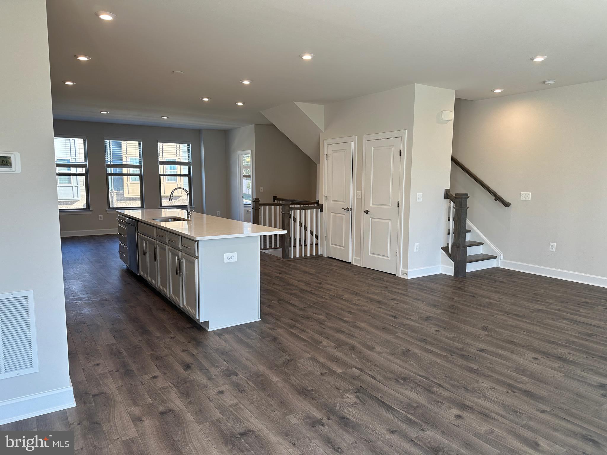 9886 Hopkins Loop Manassas, VA 20110 - Photo 19 of 50 a large white kitchen with wooden floors and a sink
