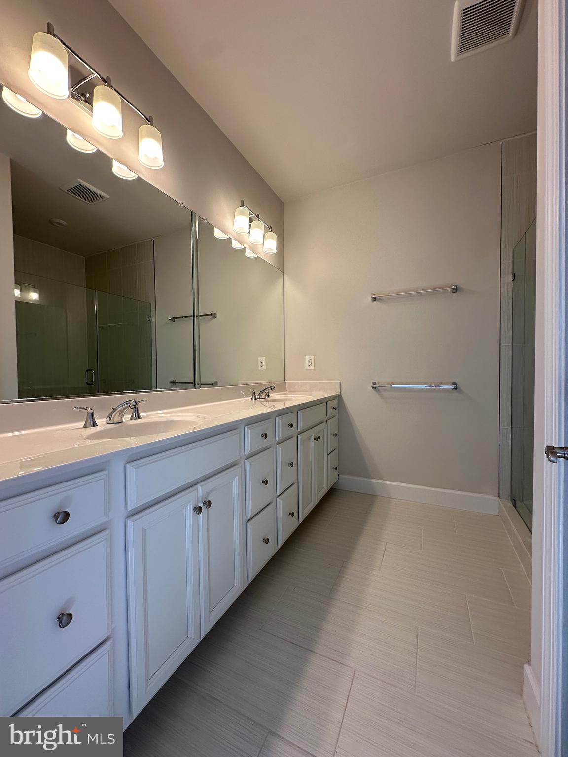 9886 Hopkins Loop Manassas, VA 20110 - Photo 34 of 50 a bathroom with a double vanity sink and mirror