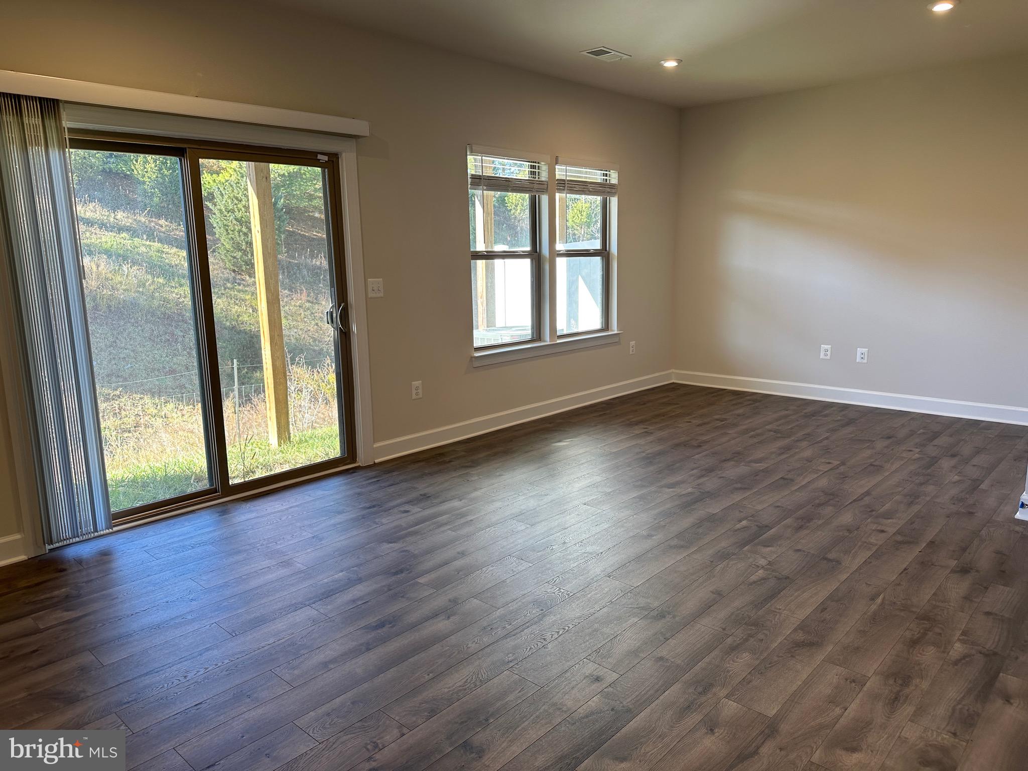 9886 Hopkins Loop Manassas, VA 20110 - Photo 42 of 50 a view of an empty room with wooden floor and a window