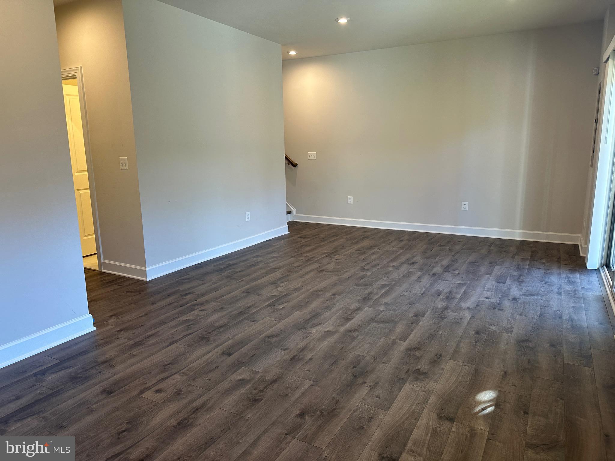 9886 Hopkins Loop Manassas, VA 20110 - Photo 45 of 50 a view of an empty room with wooden floor and a window