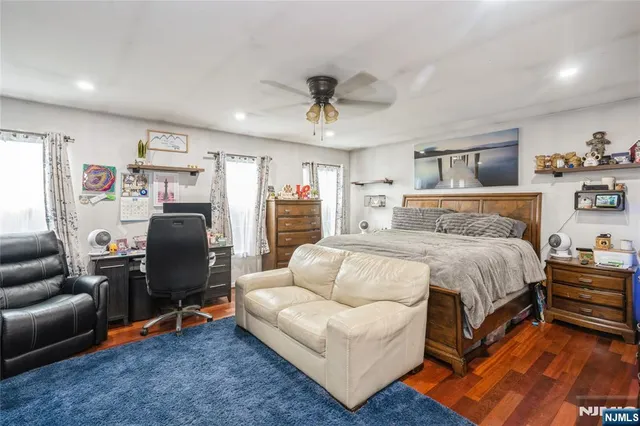 a bedroom with furniture refrigerator and window