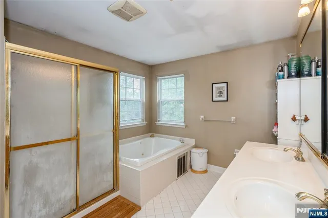 a bathroom with a bathtub and a shower