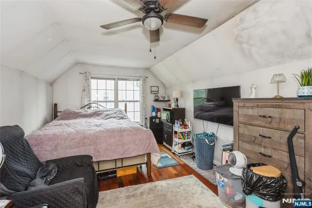 a bathroom with a granite countertop bathtub shower sink vanity and toilet