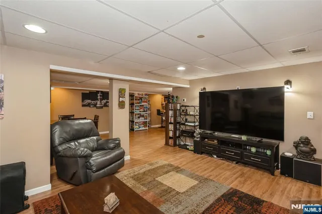a view of a room with lots of wooden furniture and windows