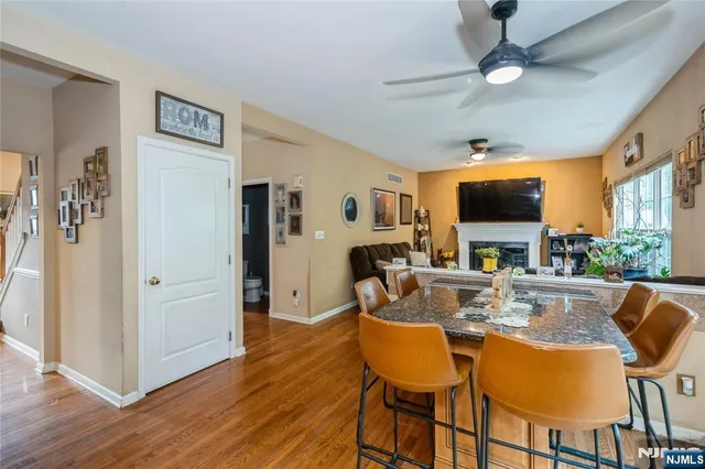 a dining room with furniture a window and a flat screen tv