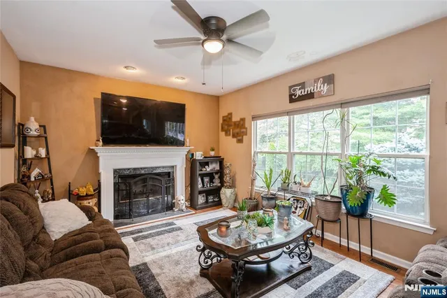 a living room with furniture a fireplace and a flat screen tv