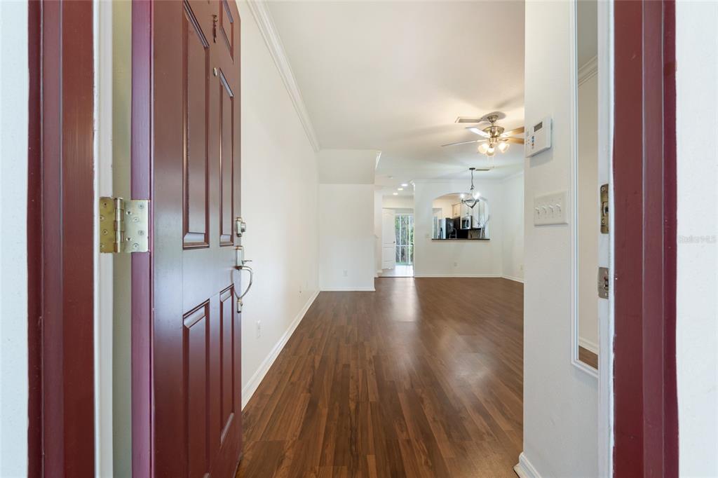 15929 Fishhawk Creek Lane Lithia, FL 33547 - Photo 21 of 25 a view of a hallway with wooden floor and staircase