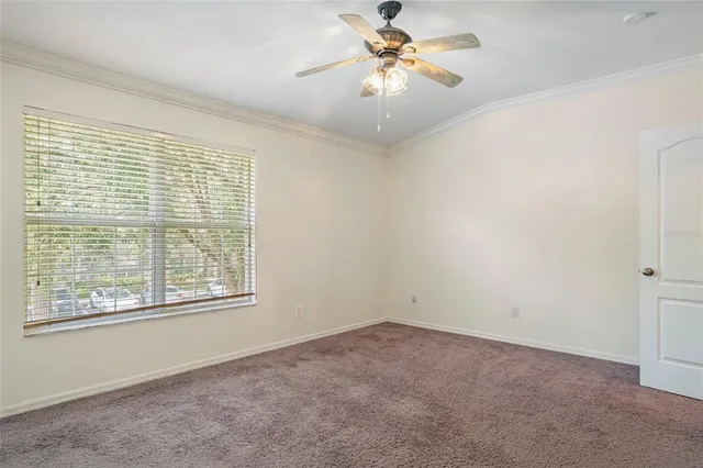 a view of a room with wooden floor chandelier and a window