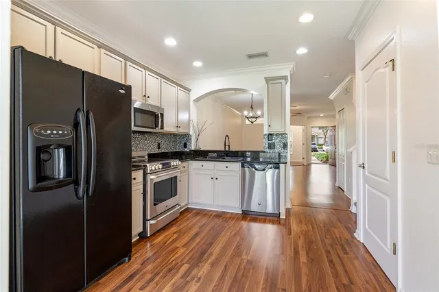 a kitchen with stainless steel appliances a refrigerator sink and cabinets
