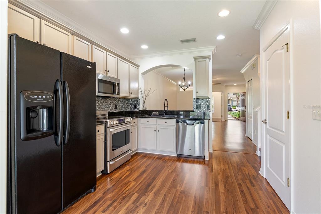 15929 Fishhawk Creek Lane Lithia, FL 33547 - Photo 9 of 25 a kitchen with stainless steel appliances a refrigerator sink and cabinets
