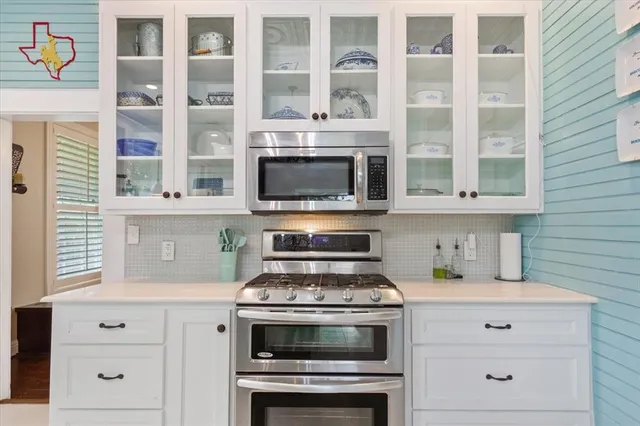 a stove top oven sitting inside of a kitchen