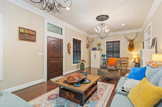 a living room with furniture and a chandelier