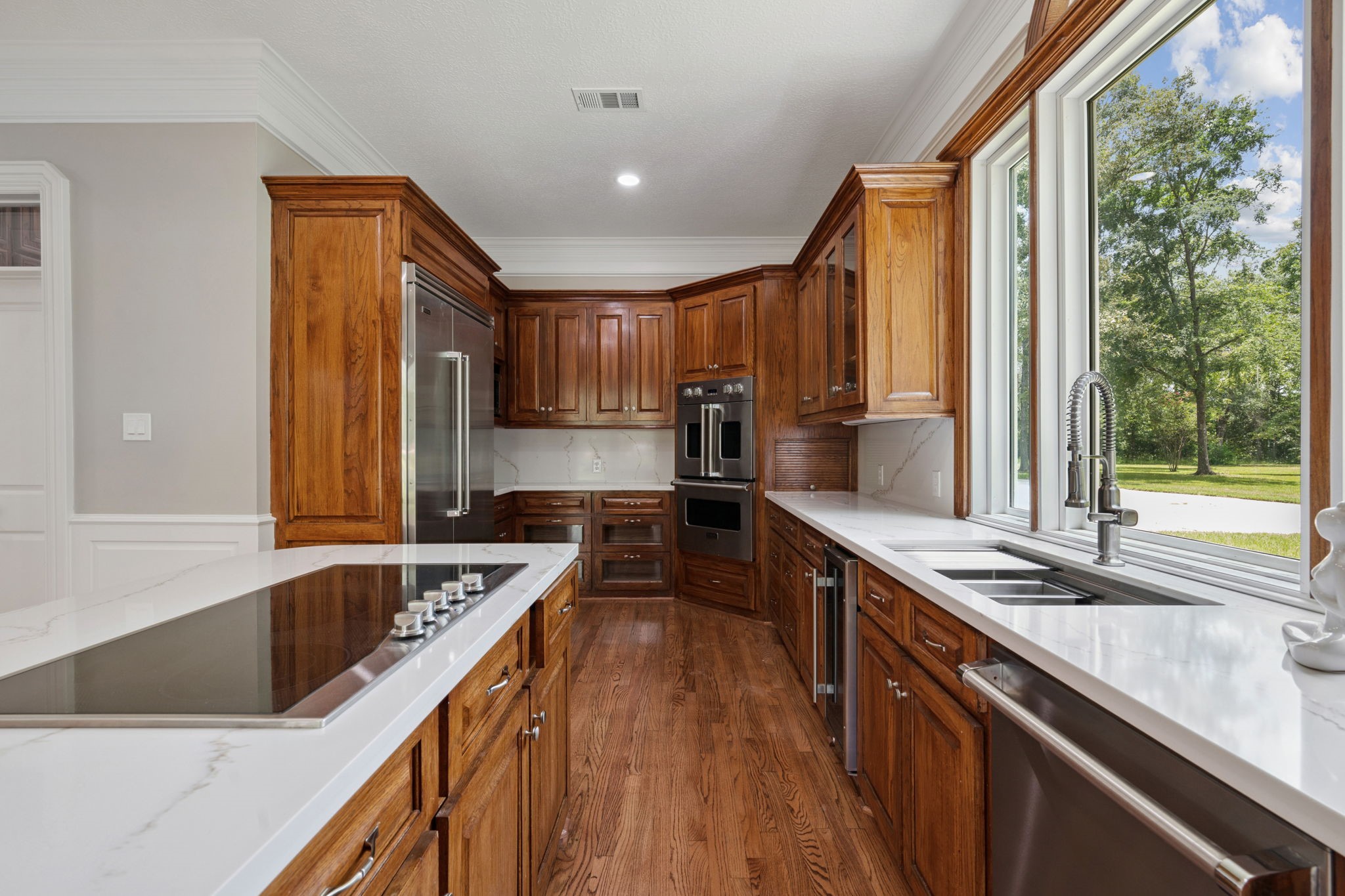 18489 Country Pl Drive Conroe, TX 77302 - Photo 13 of 50 a kitchen with kitchen island granite countertop a sink a counter top space and stainless steel appliances