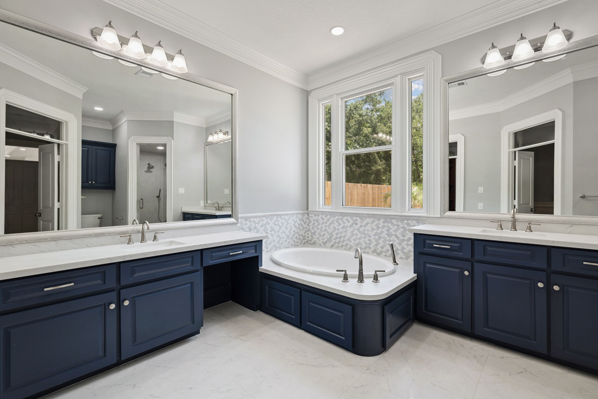 18489 Country Pl Drive Conroe, TX 77302 - Photo 20 of 50 a bathroom with a tub double vanity sink shower and mirror