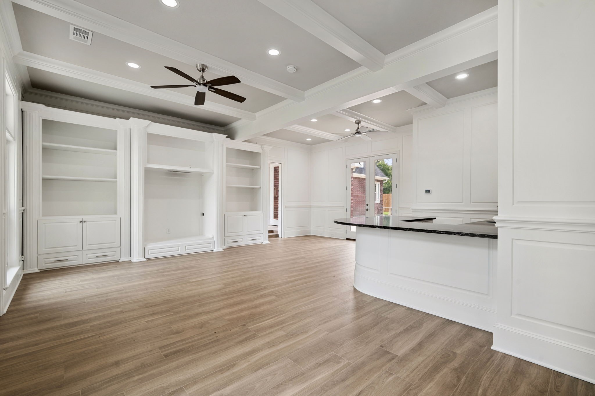 18489 Country Pl Drive Conroe, TX 77302 - Photo 37 of 50 an empty room with wooden floor kitchen view and windows